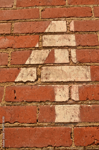 vintage painted number four on red brick photo