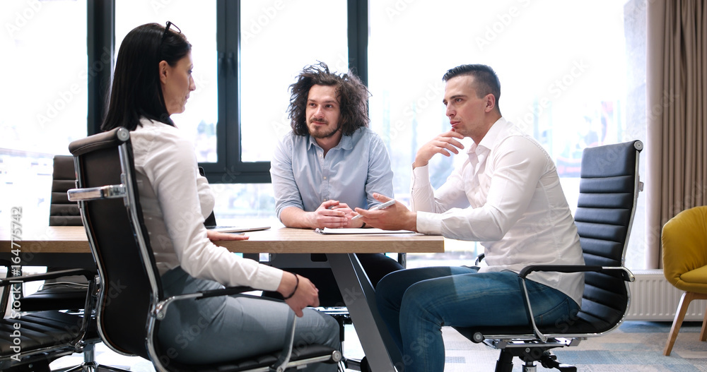 Startup Business Team At A Meeting at modern office building Startup Business Team At A Meeting at modern office building