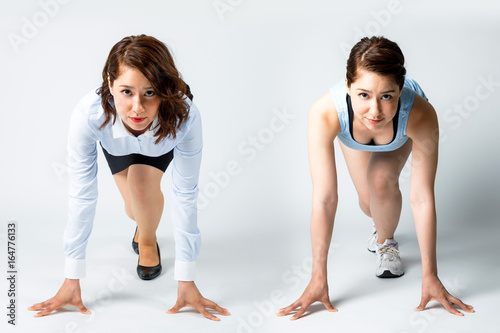 Start of Business concept. businesswoman and runner (same person) posing a crouch start.