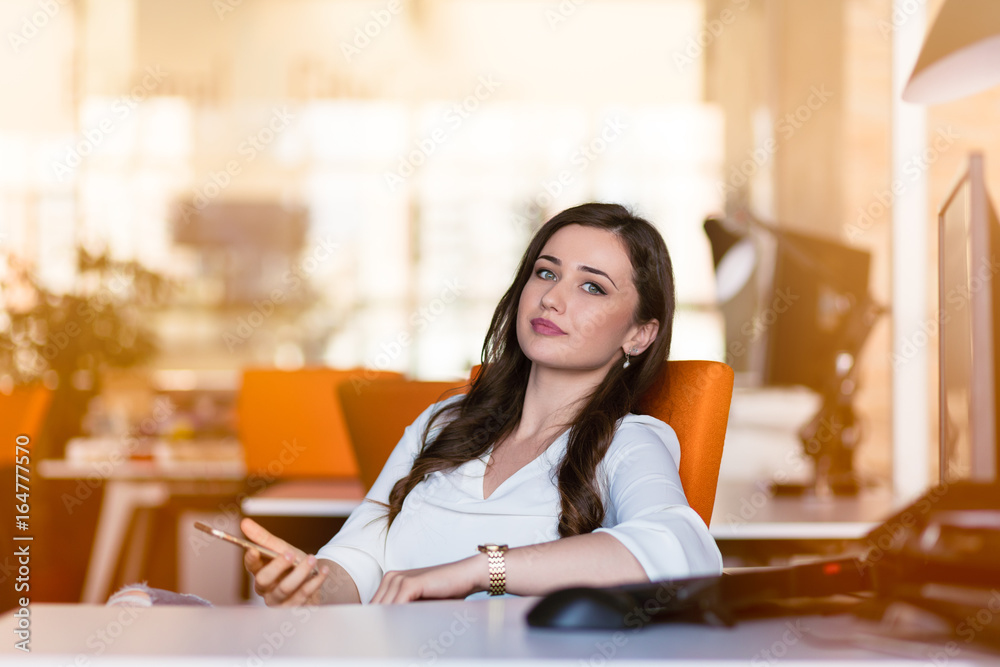 Happy pensive businesswoman planning and looking sideways at office Happy pensive businesswoman planning and looking sideways at office