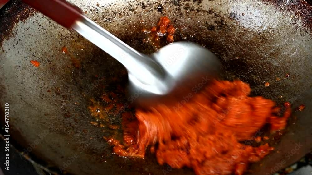 frying curry paste in pan , to make Thai wild spicy curry.