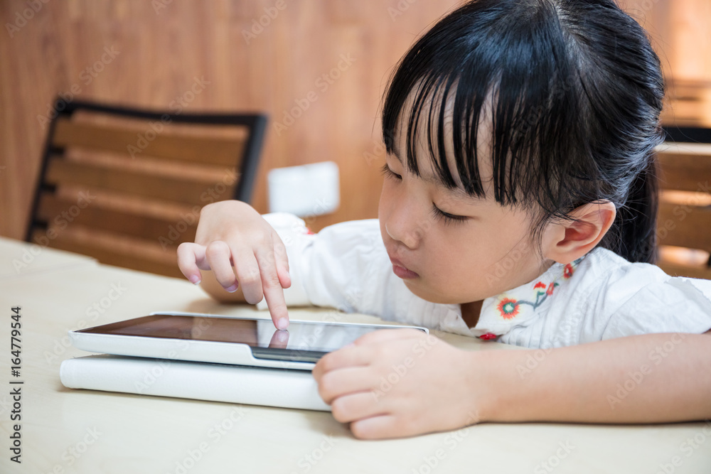 Asian Chinese little girl playing tablet computer Asian Chinese little girl playing tablet computer