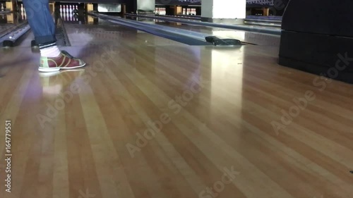 Footwork of someone bowling in a bowling alley