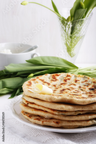 Khychiny – traditional caucasian flatbread filled with сheese and herbs. photo