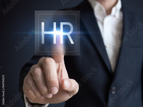 Human resources concept with manager in office touching white board computer interface about skills, training and performance