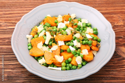 Warm salad with roasted pumpkin, peas and cheese brie