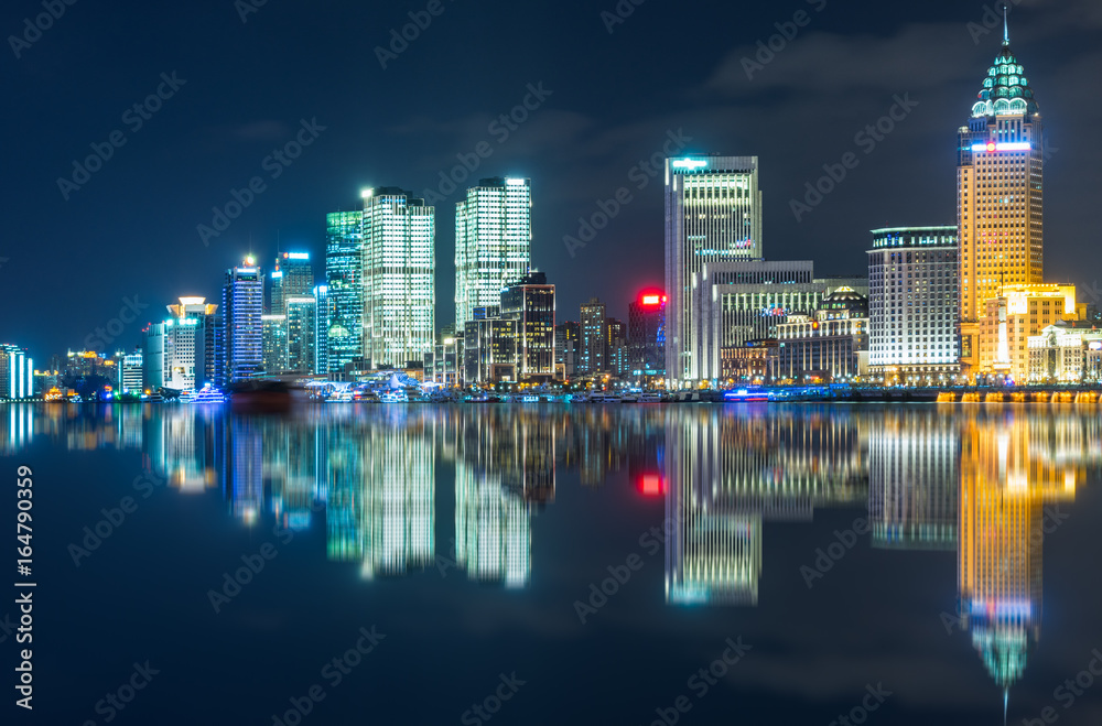 Fototapeta premium Illuminated City At Waterfront in city of China.