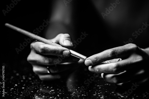 The artist's hands hold a brush