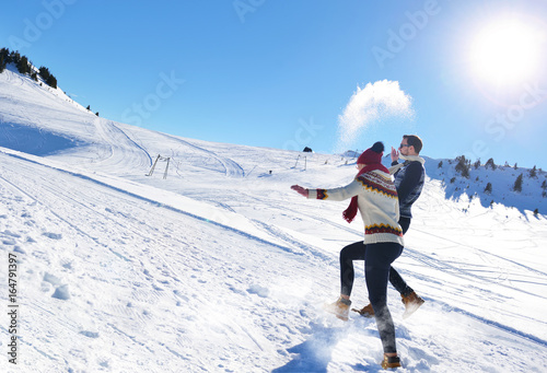 Cheerful young couple having fun in winter park