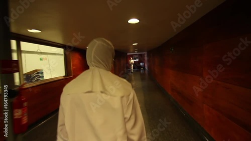 Worker walking through corridor in suit photo