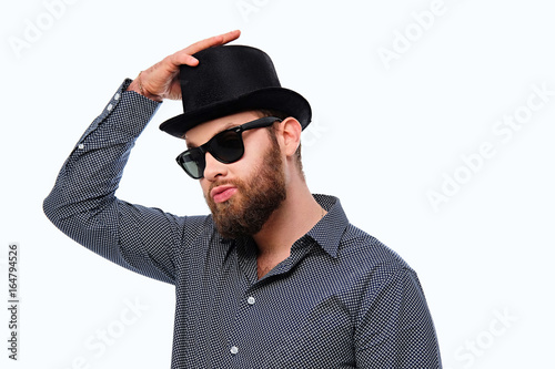 Bearded hipster male in sunglasses and cylinder hat. © Fxquadro