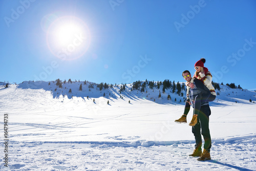 Loving couple playing together in snow outdoor.