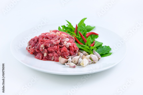 Ingredients of spicy fried meat with basil leaves.