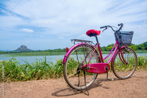 The bicycle stands on a village road at Thalkote lake near Sigiriya. Renting a bicycle and cycling around Sigiriya village is the most popular way among the tourists 