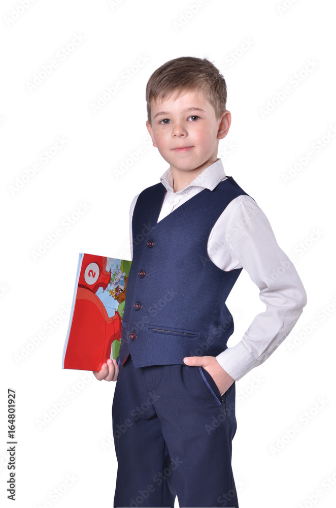 Schoolboy in blue suit on white background with book in his hand Schoolboy in blue suit on white background with book in his hand