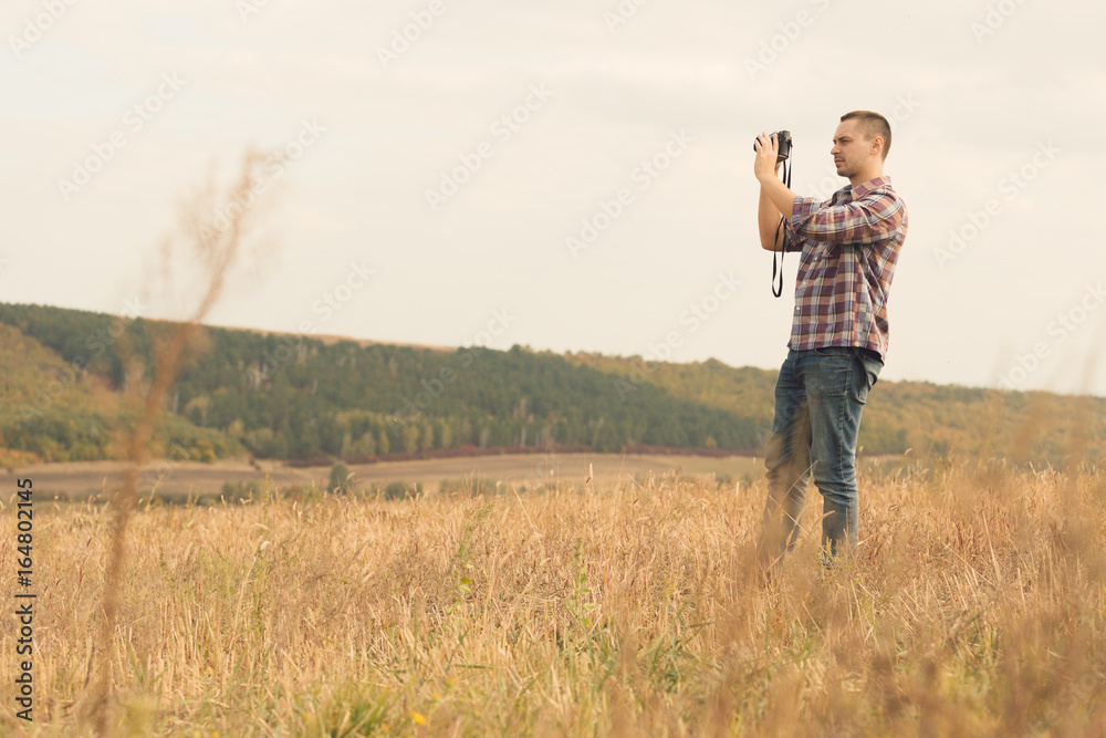 Attractive male photographer outdoors at sunset Attractive male photographer outdoors at sunset