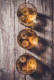 Whiskey glasses on an old wooden table. Close up
