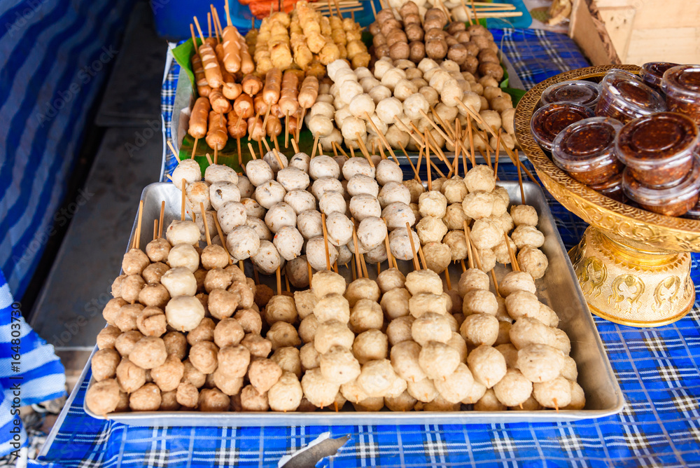 Thailand street food is everywhere. street barbecue grill chicken and pork meat balls are tasty with sweet sour sauce..