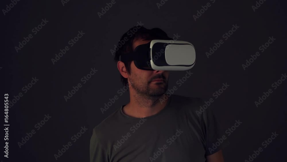 Casual bearded adult man with virtual reality VR headset indoors Casual bearded adult man with virtual reality VR headset indoors