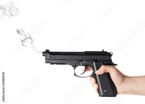 Man's hand holding gun on white background