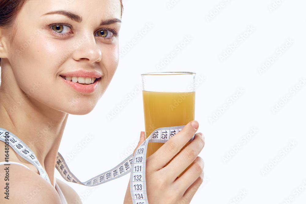 Young beautiful woman on white isolated background holds juice, diet, slimming Young beautiful woman on white isolated background holds juice, diet, slimming