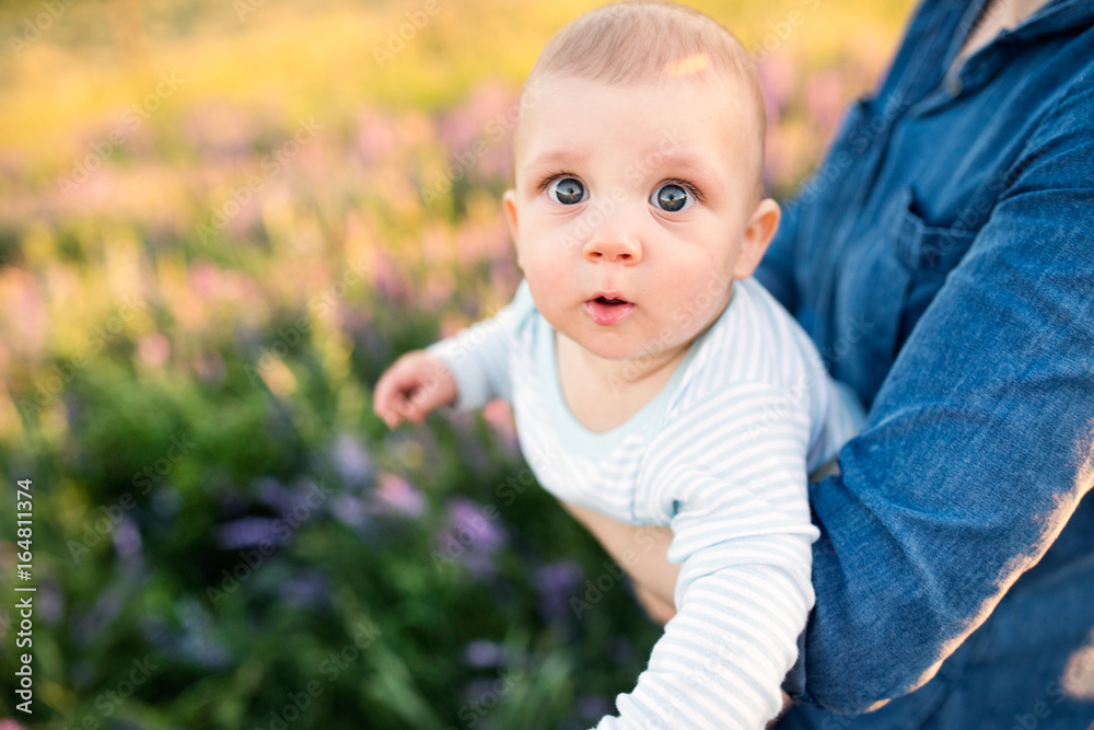 Unrecognizable mother in nature with baby son in the arms. Unrecognizable mother in nature with baby son in the arms.