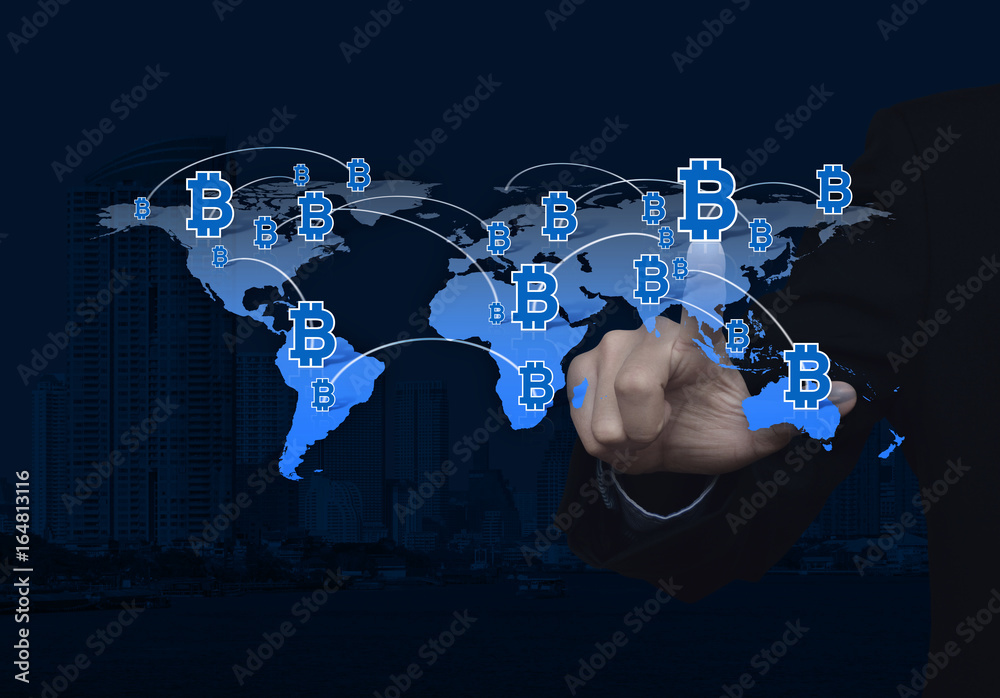 Businessman pressing bit coin icon with world map and modern office tower, Choosing bitcoin concept, Elements of this image furnished by NASA Businessman pressing bit coin icon with world map and modern office tower, Choosing bitcoin concept, Elements of this image furnished by NASA