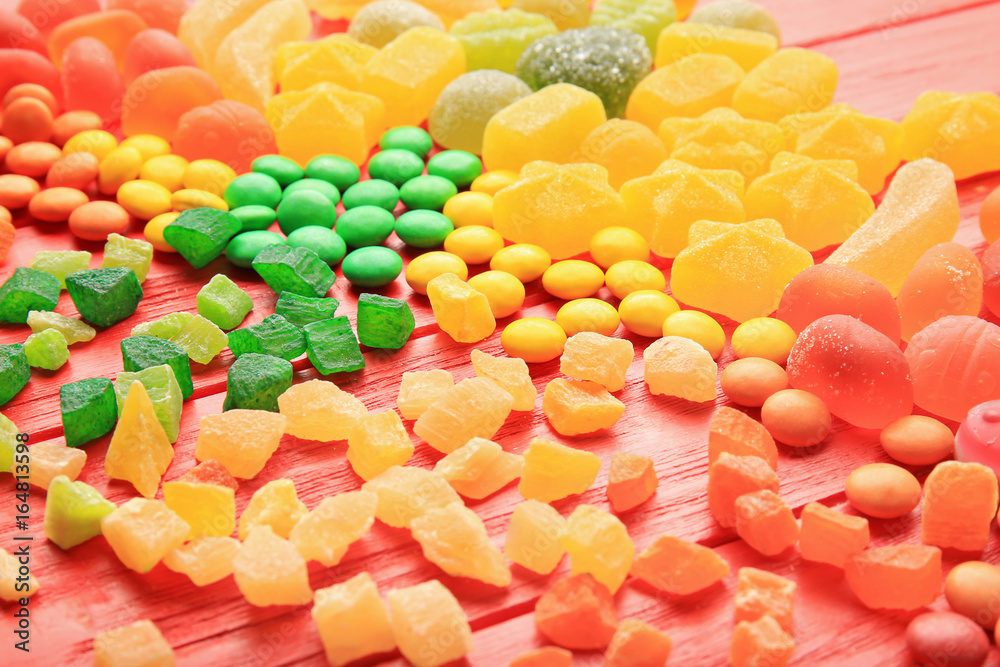 Composition of delicious candies on red background Composition of delicious candies on red background