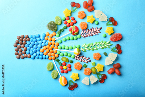 Composition of delicious candies on blue background