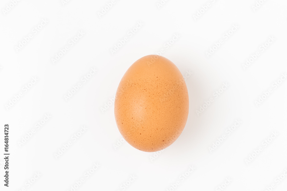 Single brown chicken egg on white background Single brown chicken egg on white background