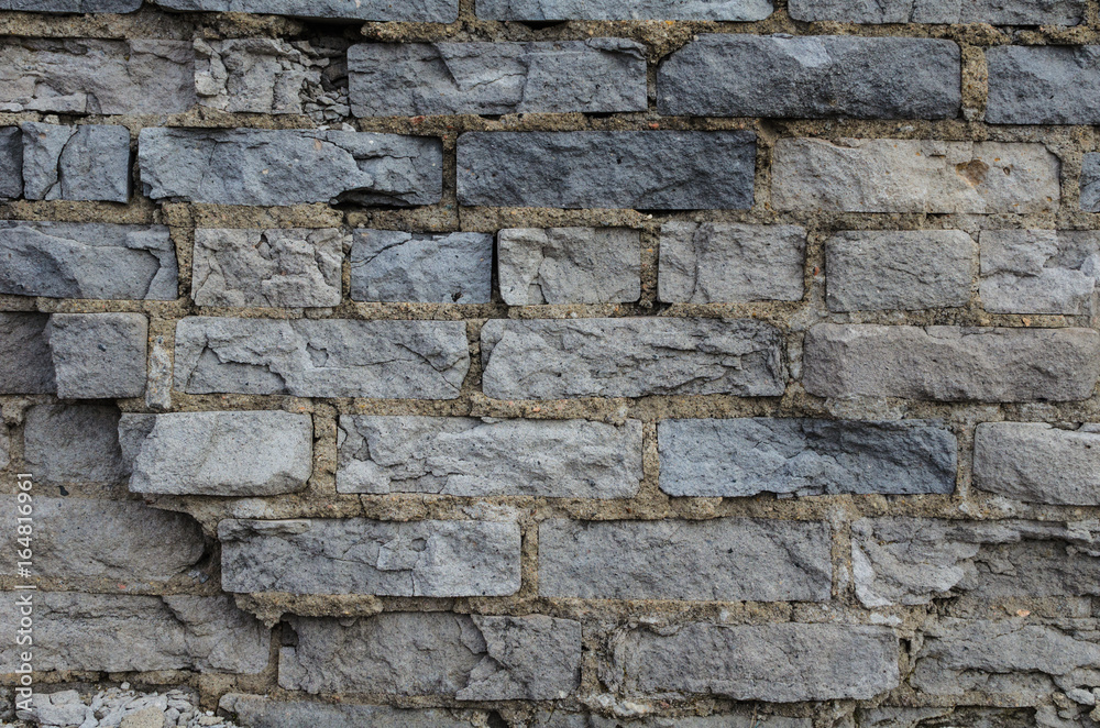 Ruined wall of brick gray.