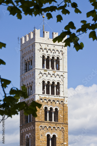 Saint Michael's bell tower detail built with stone and white marble (Italy - Tuscany - Lucca city) - Image with copy space