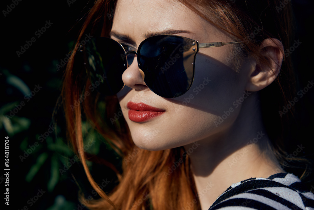Young beautiful woman in sunglasses on the street Young beautiful woman in sunglasses on the street
