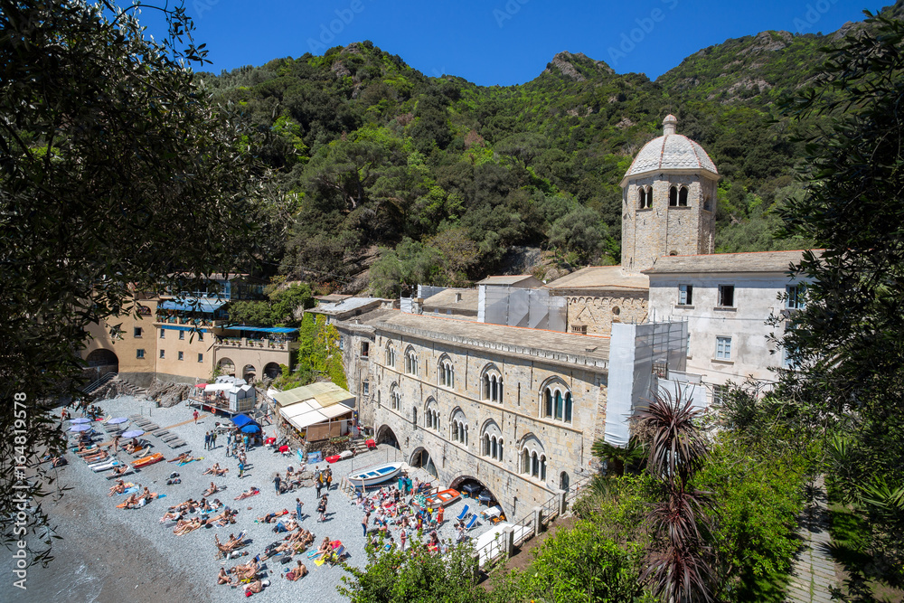 SAN FRUTTUSO DI CAMOGLI, ITALY, MAY, 4, 2016 - San Fruttuoso di Camogli, Ligurian coast, Genoa province, with its ancient Abbaey, the beach and tourists.
