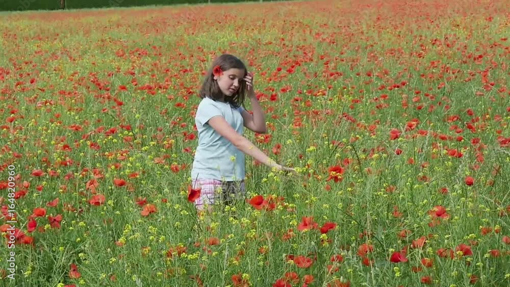 Young teenage girl in poppy field, slow motion Young teenage girl in poppy field, slow motion