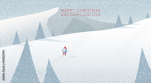 Winter mountain landscape scenery, walking Santa Claus with his bag full of presents in deep snow with pine trees surrounding him and blue sky.