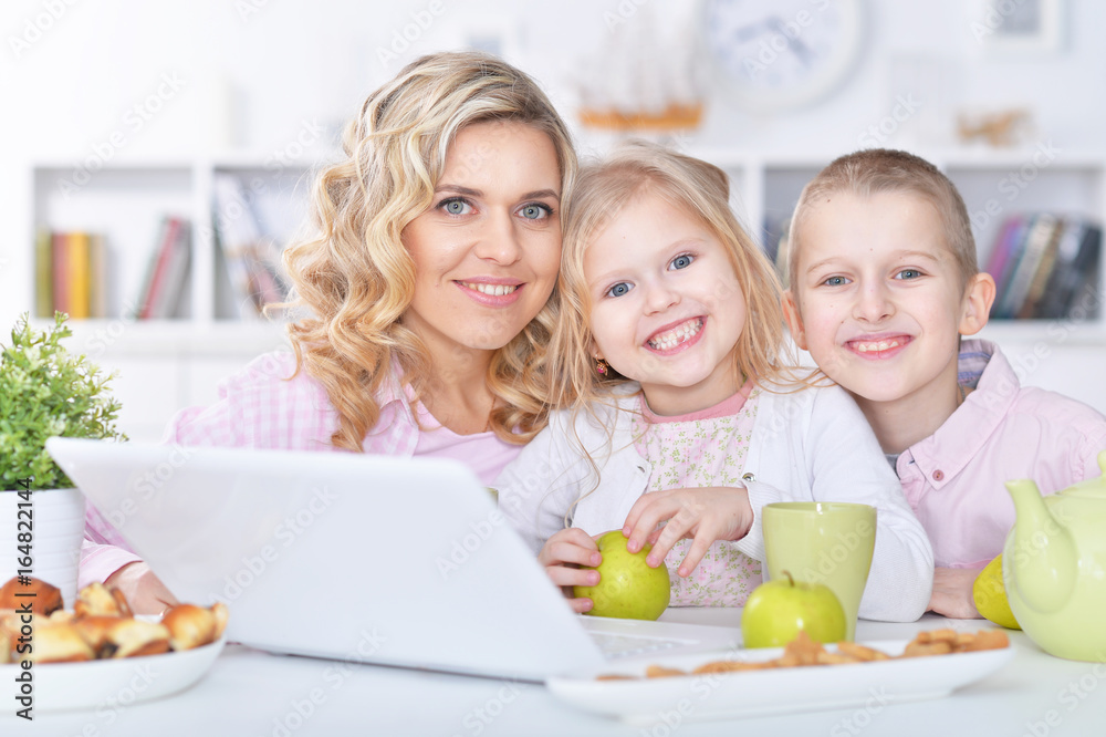 mother and children with laptop