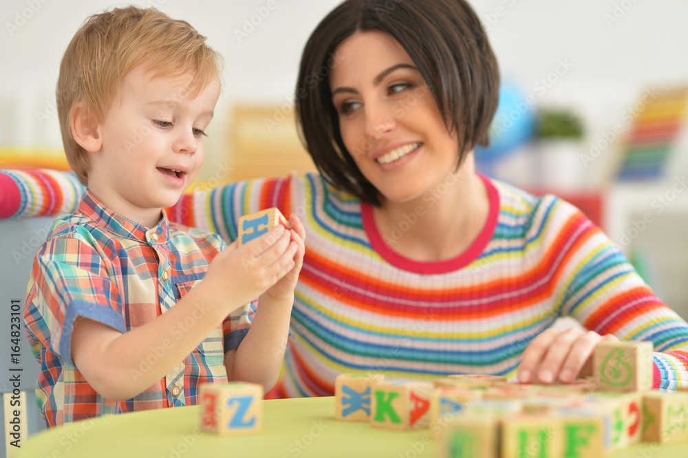 Fototapeta premium Young mother playing with son