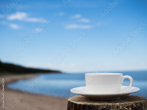 Coffee espresso on wood table nature background on the beach, Beauty nature background