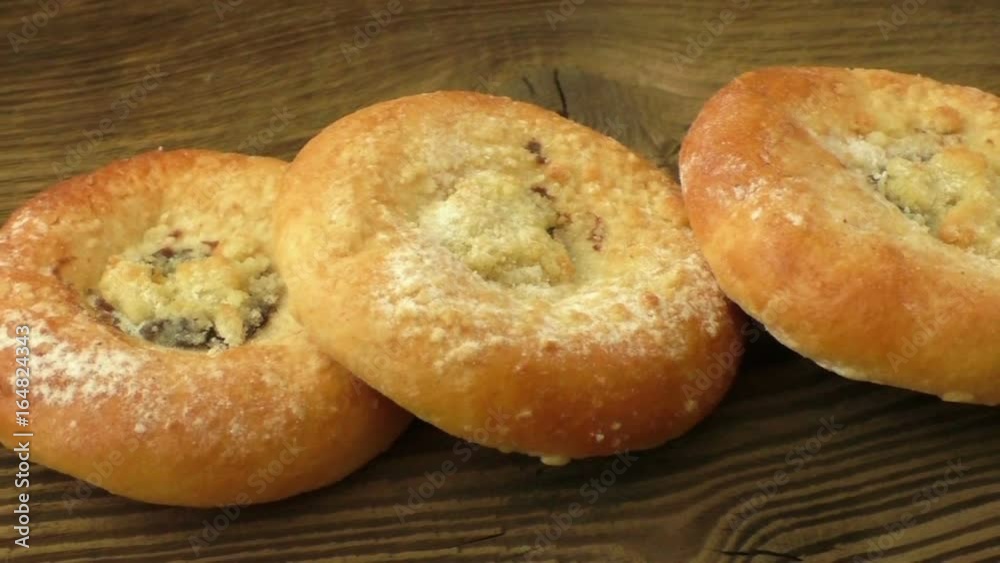 Fresh sweet homemade buns on wooden plank. Baked pastry
Fresh sweet homemade buns on wooden plank. Baked pastry