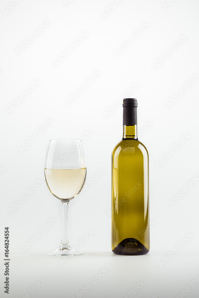 close-up view of white wine in glass and bottle isolated on white close-up view of white wine in glass and bottle isolated on white