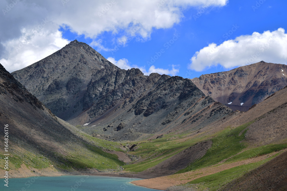 Landscape of hills, blue sky and lake in Altai mountains
