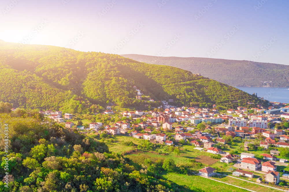 Beautiful city in the mountains near the sea in the sunlight, top view