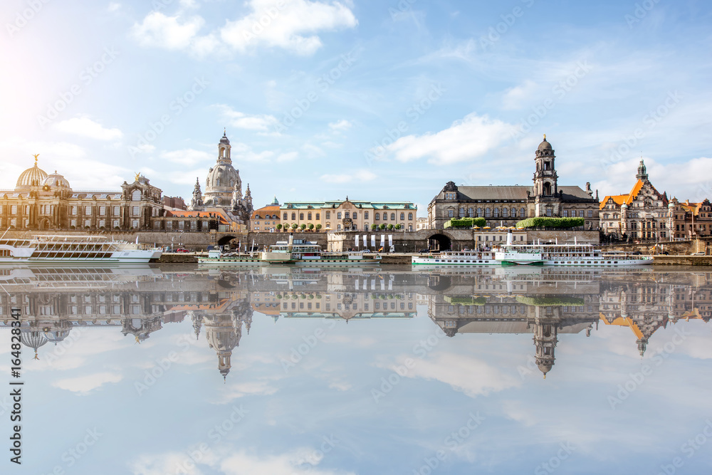 Panoramic view on the riverside of the old town with beautiful reflection on the water during the sunny weather in Dresden city, Germany Panoramic view on the riverside of the old town with beautiful reflection on the water during the sunny weather in Dresden city, Germany