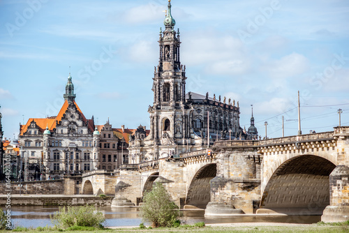 View on the riverside of Elbe river with catholic church  city gates and bridge during the sunny weather in Dresden city  Germany