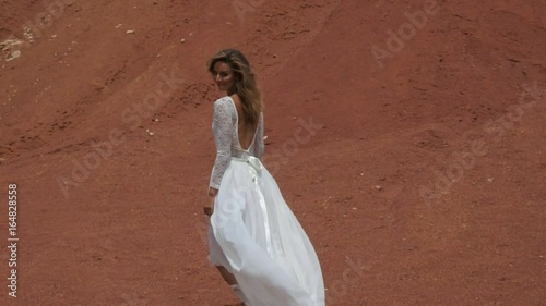 Beautiful woman walking away and look back