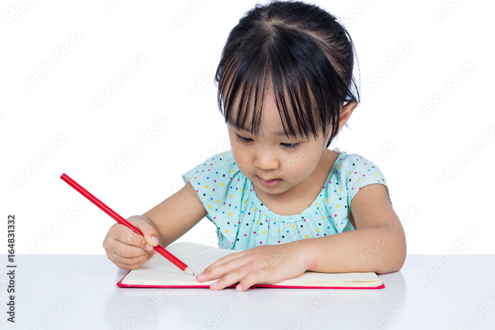 Asian Little Chinese girl writing on exercise book Asian Little Chinese girl writing on exercise book
