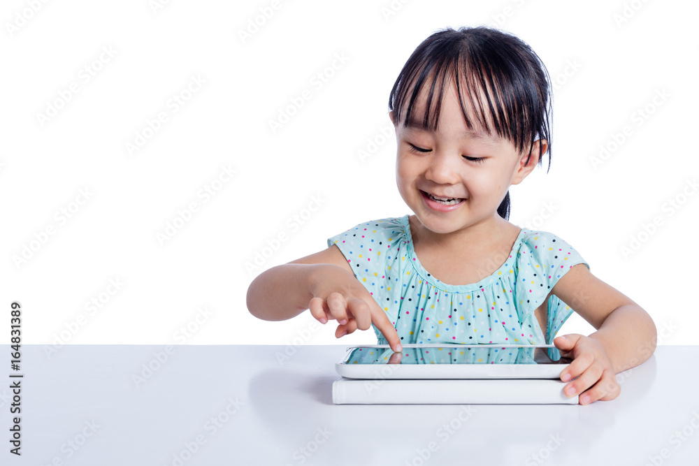 Asian Chinese little girl playing with tablet computer Asian Chinese little girl playing with tablet computer