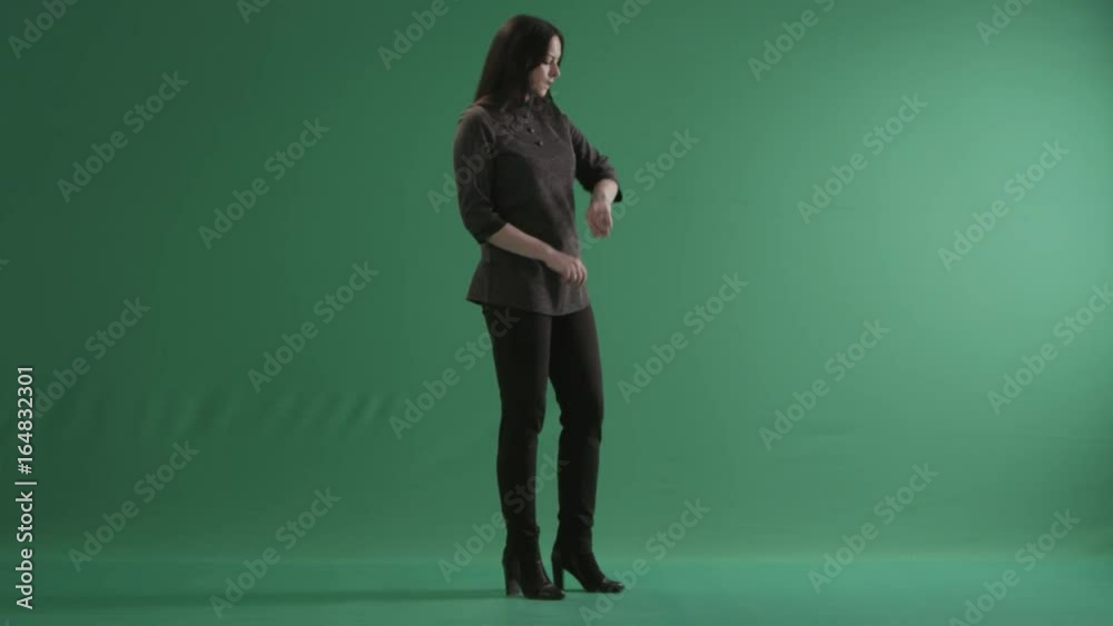 Young impatient woman looking at her wristwatch Young impatient woman looking at her wristwatch