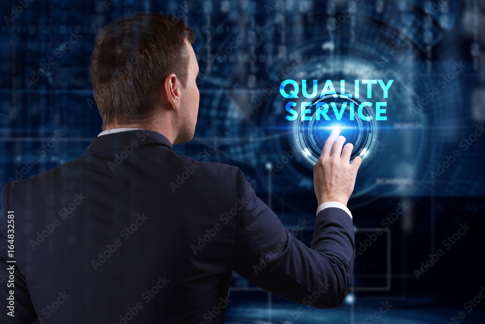 Business, Technology, Internet and network concept. Young businessman working on a virtual screen of the future and sees the inscription: Quality service Business, Technology, Internet and network concept. Young businessman working on a virtual screen of the future and sees the inscription: Quality service